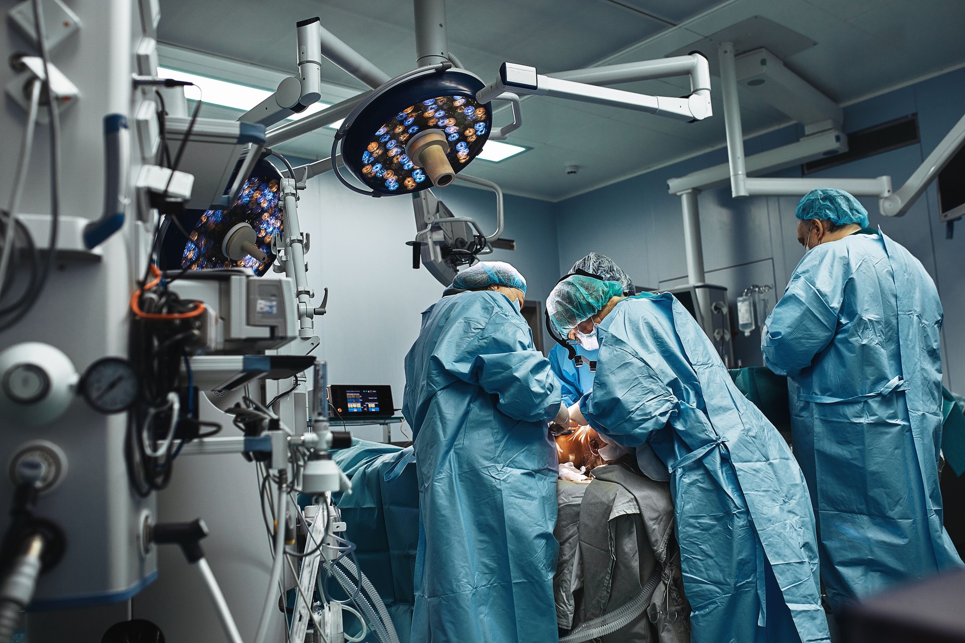 A team of professional surgeons works in the operating room. A real operation to remove a cancerous tumor. Life saving, modern operating room. Fight for life